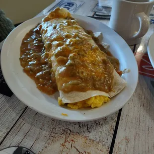 Huge breakfast burrito smothered with green chili.