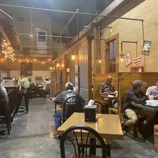 people sitting at tables in a restaurant