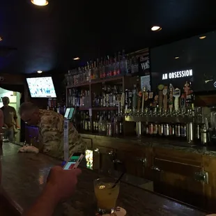 a man using his cell phone at the bar