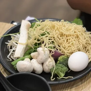 a plate of noodles and vegetables