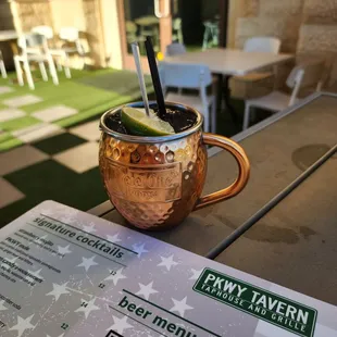 a drink in a copper mug