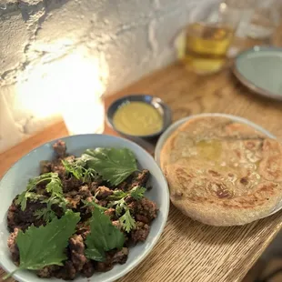 Lamb with pita and green harissa