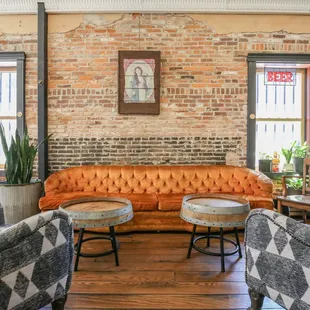a living room with a brick wall