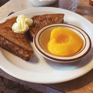 French toast half order - homemade bread and a half peach. Best French toast I've had in Vancouver. Came with both maple and berry syrup.