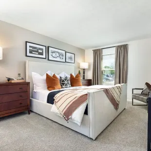 Sleek master bedroom with modern finishes and luxury carpet.