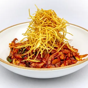 Spicy baby octopus &amp; pork belly with vegetable, sweet &amp; spicy sauce and thinly sliced sweet potato on top.