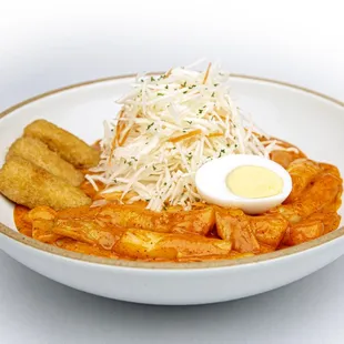 Rose rice cake with fish cake, boiled egg, fried cheese stick, sweet &amp; spicy sauce and thinly sliced cabbage.