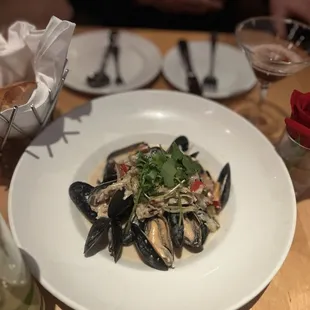 a plate of mussels and a glass of wine