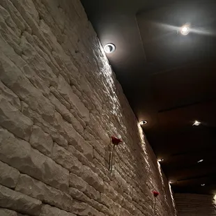 a brick wall with red roses on it