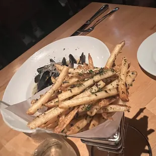 a plate of french fries and a glass of water