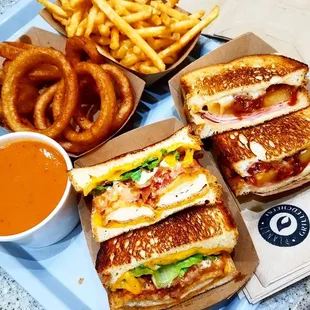 three sandwiches and a side of onion rings