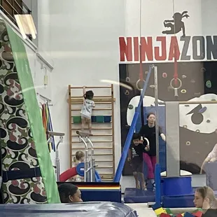 My daughter climbing the ladder and teacher Meg