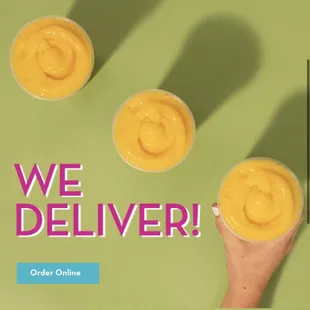 a hand holding a cup of smoothie