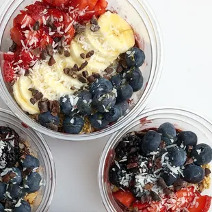three bowls of fruit and yogurt
