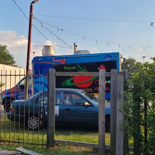 a car parked in front of a food truck