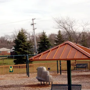 The covered benches in the middle of the playground make it shady in the middle of a hot summer's day