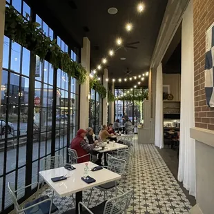 people sitting at tables in a restaurant