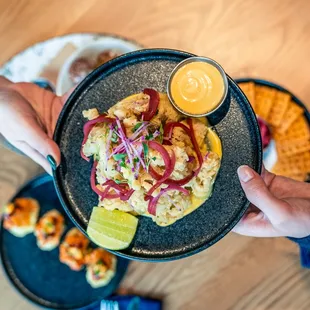 a person holding a plate of food