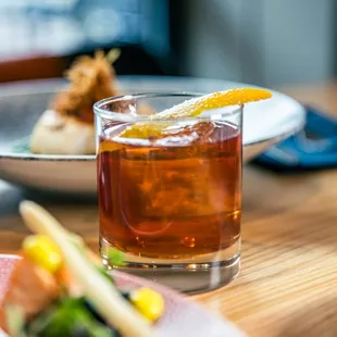 a glass of tea and a plate of food