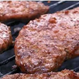 burgers cooking on a grill
