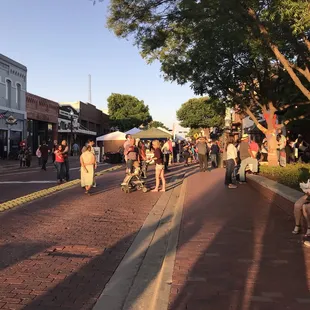 Street is closed to vehicle traffic. Art vendor booths line the streets.