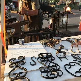 Blacksmith making metal art work.