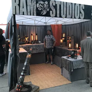 Artist makes lights from metal scraps like hub caps and chains.