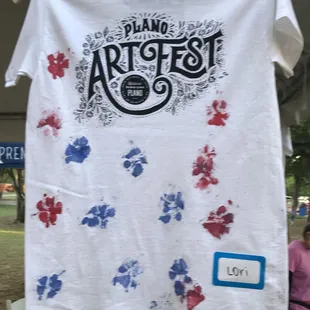 Buy a t-shirt and let your dog paint her paw prints on it. Sponsored by Camp Bow Wow