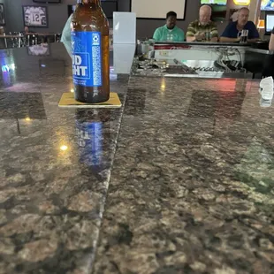 a bottle of beer on a bar