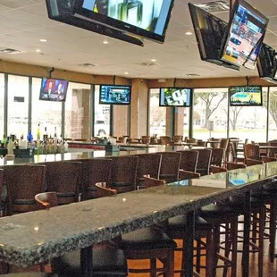 a bar with multiple televisions