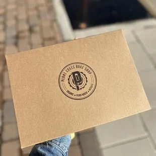 a person holding up a business card