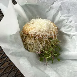 a sandwich with cheese and sprouts