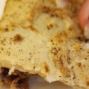 a person holding a piece of food