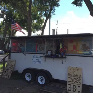a white food truck parked on the side of the road