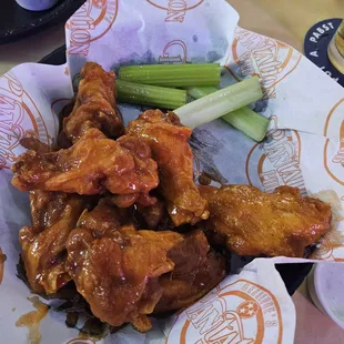 chicken wings and celery in a basket