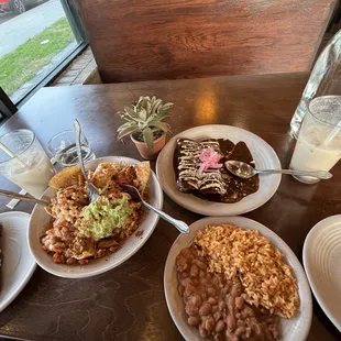 Loaded Al Pastor Nachos, Enmoladas with rice and beans and homemade Horchata