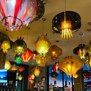 a large number of colorful lights hanging from the ceiling