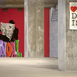 a man reading a newspaper in a parking garage