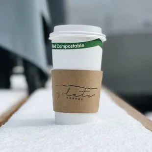 a cup of coffee sitting on a table