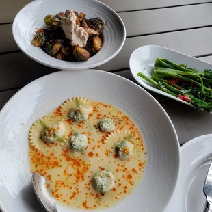 Parmesan broth ravioli, crispy brussels, and broccolini
