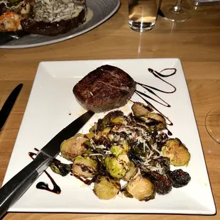a steak and vegetables on a white plate