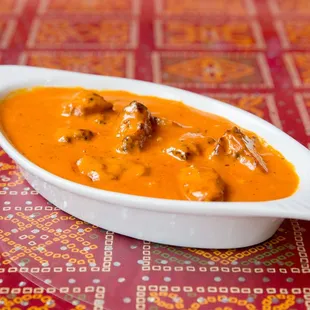 a bowl of curry with meat in it