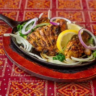 a chicken dish with onions and lemon