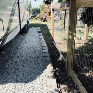 a rv parked next to a fence