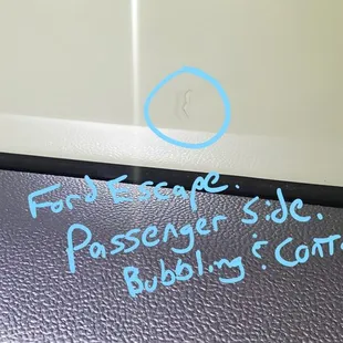 Ford Escape Passenger Window. There is bubbling and contamination (appears to be a hair) under the tint film.