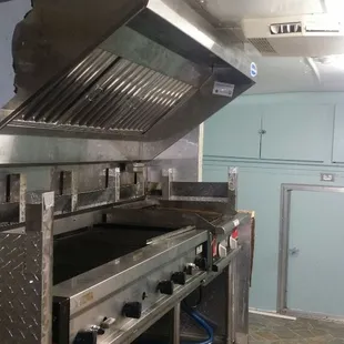 a commercial kitchen with stainless steel appliances