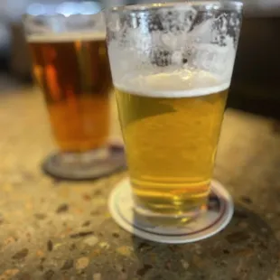 two glasses of beer on a table