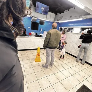a group of people standing in a kitchen