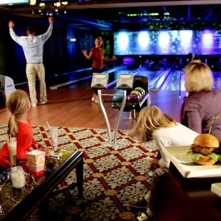 a family watching a bowling game