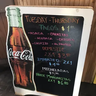 a chalk board with a coca cola sign